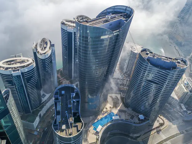 Aerial view of modern Abu Dhabi towers representing ownership costs and community management in property investment developments