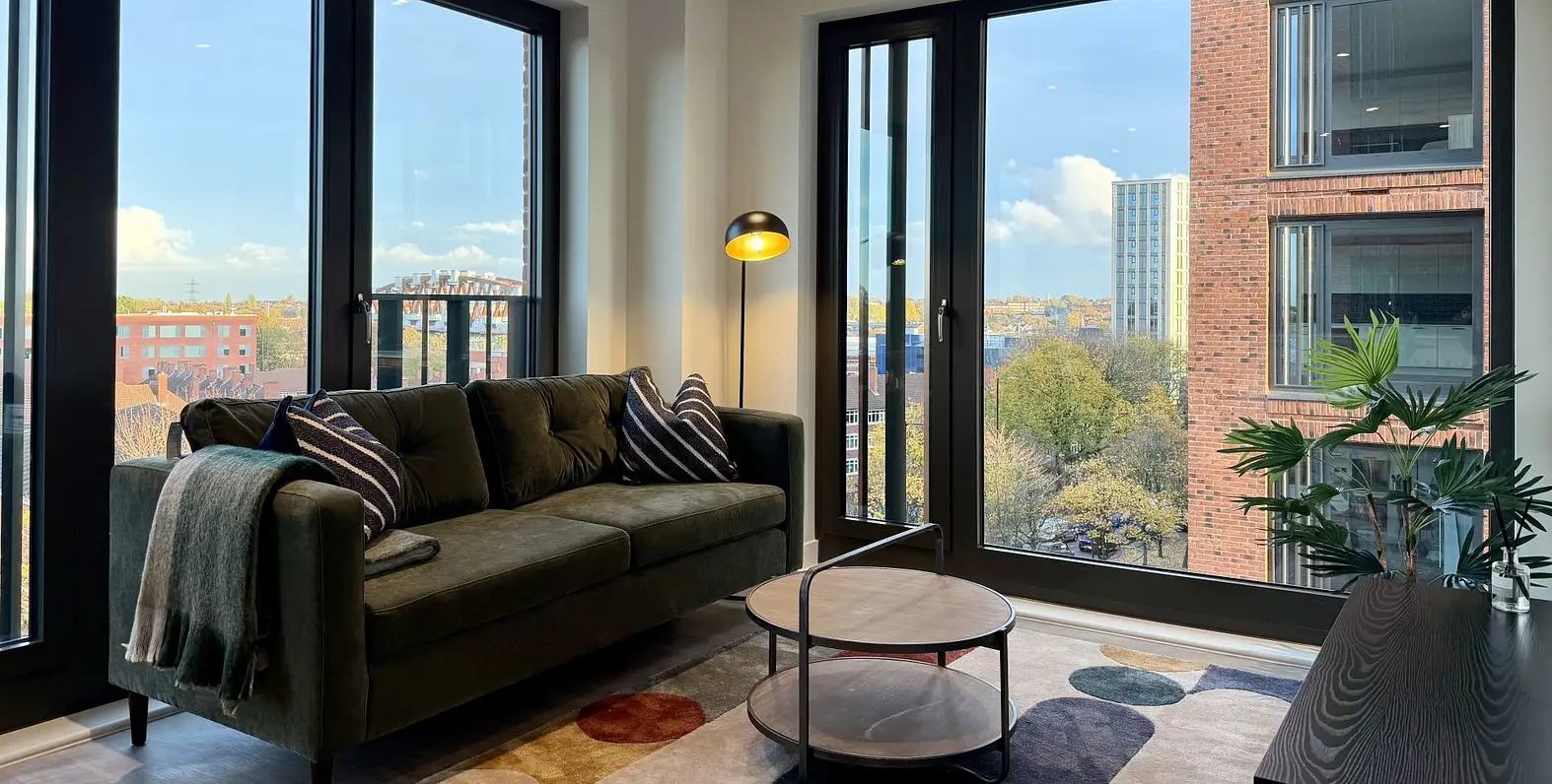 Modern living room with sofa coffee table and floor lamp in city apartment showcasing property furniture packages for investors