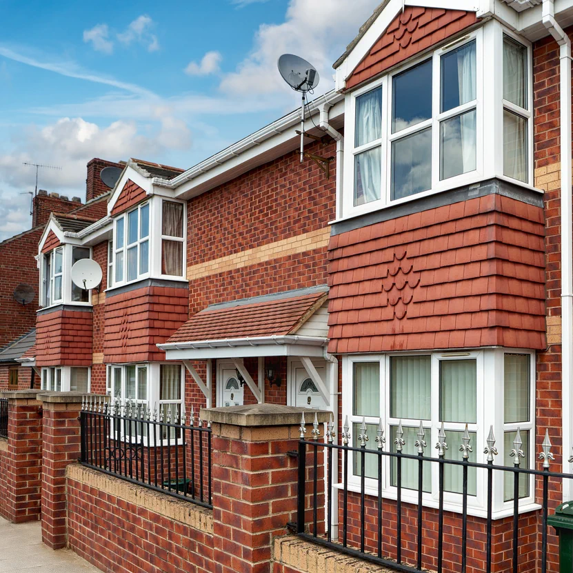 UK residential terraced houses with brick facades and bay windows illustrating modern property developments in the UK market