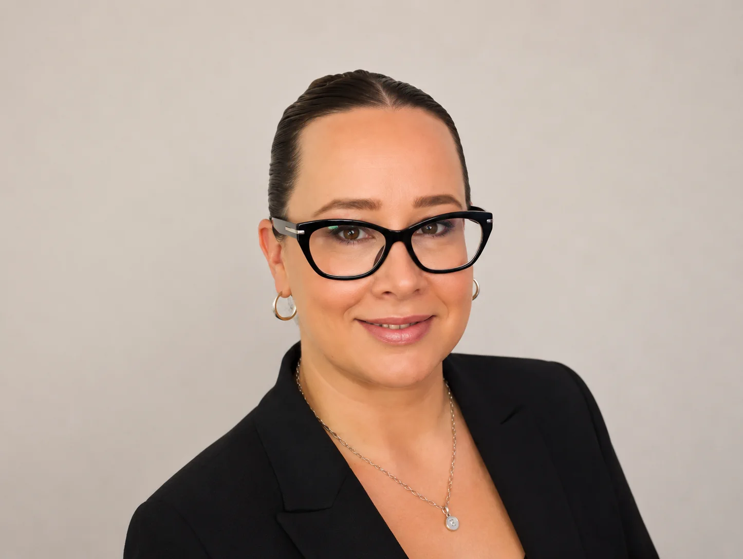 Professional woman smiling in office representing marketing manager driving property investment brand growth and investor engagement