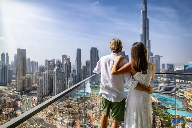 Couple overlooking Dubai skyline and Burj Khalifa from balcony highlighting ownership framework for overseas property investors