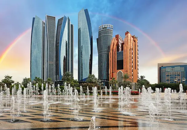 Abu Dhabi skyline with modern towers and fountains representing tax efficiency benefits for property investment in the UAE