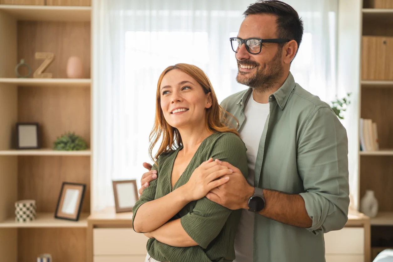 Couple at home looking happy and relaxed representing who buy to let property investment is suitable for in the UK