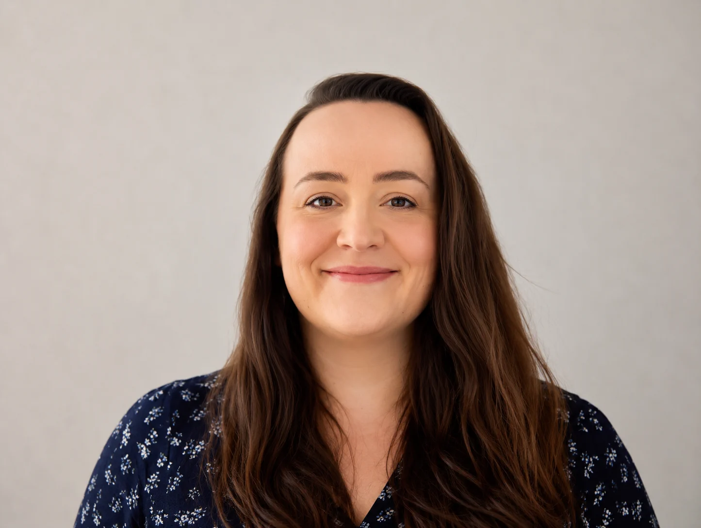 Professional woman smiling representing operations manager overseeing property investment processes and business efficiency