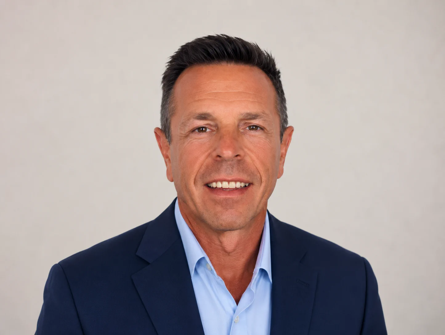 Professional man in suit smiling representing Paul Cox CEO property investment expert with extensive UK and European experience