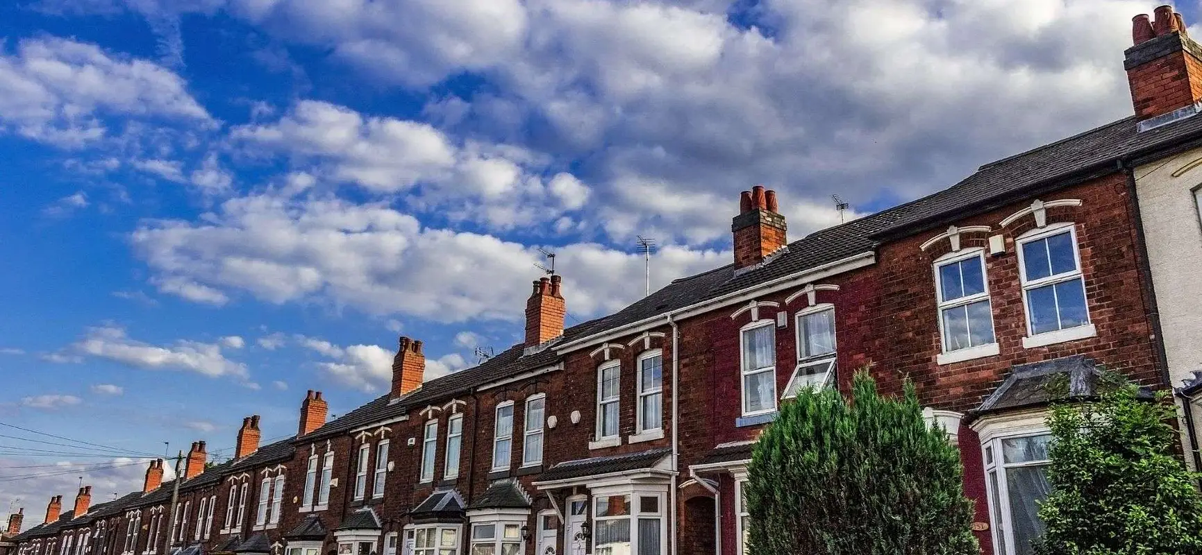 Row of traditional UK terraced houses representing HMO social housing investments with 365 Invest and stable rental income